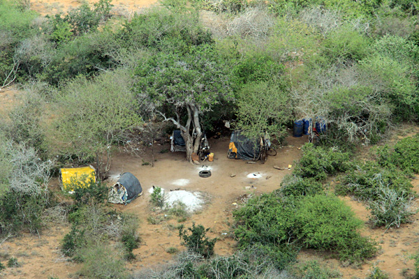 Temporary camps hidden under acacia scrub litter the landscape