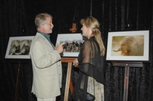Stephen Nolan, USA Ambassador, discuss wildlife photos on exhibit with Kelly Landen
